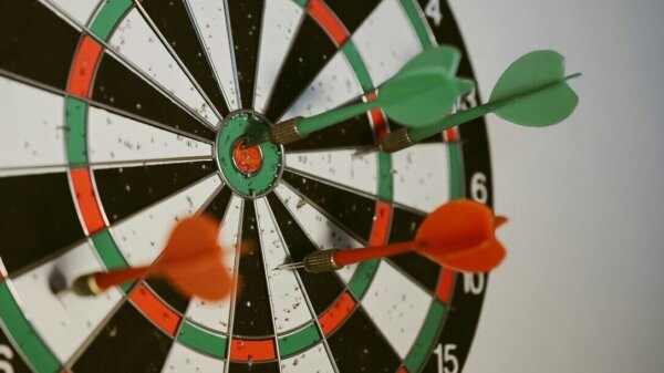 Close-up view of a dartboard with darts in the main section